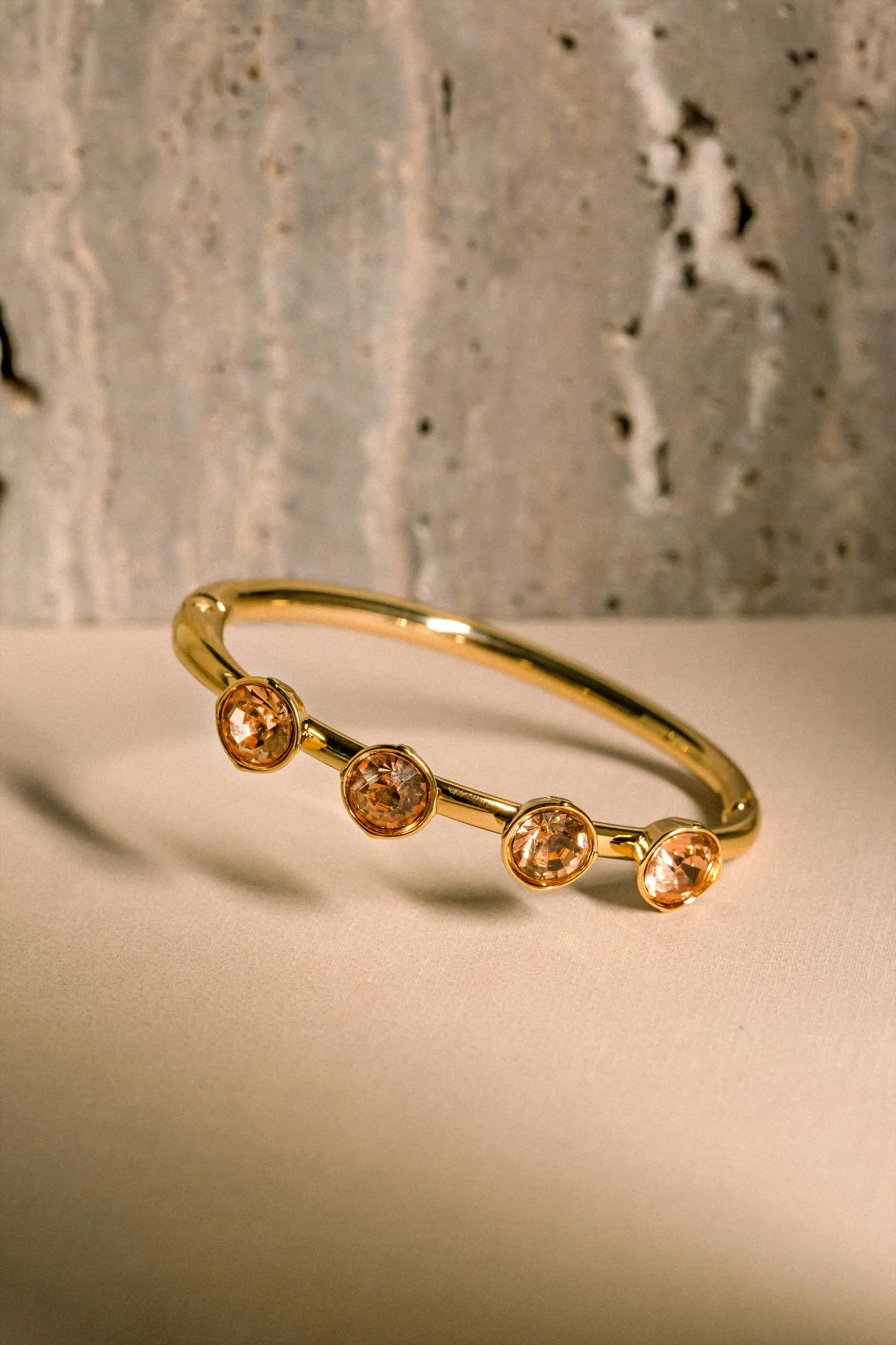 Elena Cuff Bracelet resting against a pale stone