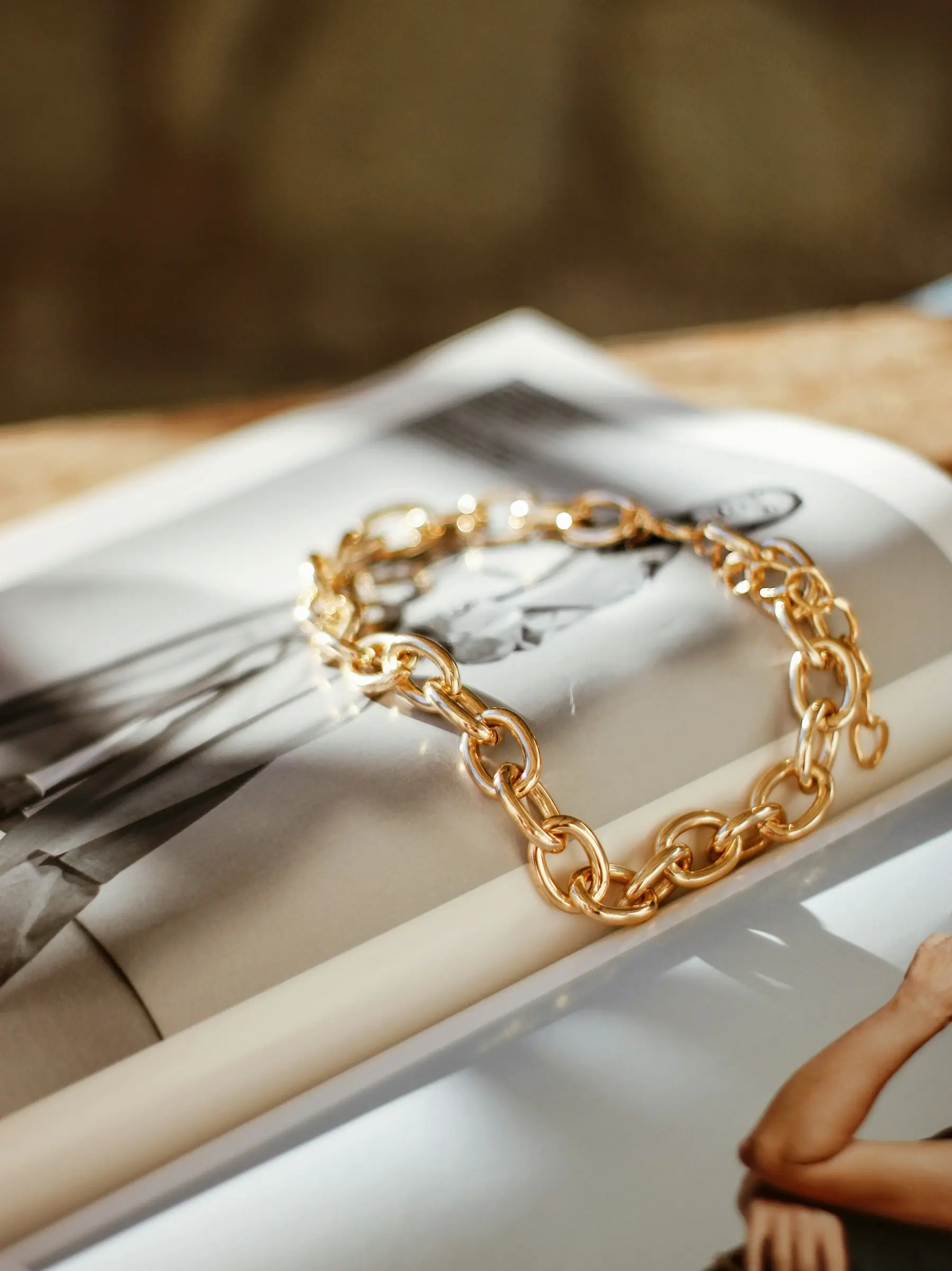 Elena Signature Bracelet laid across a magazine page