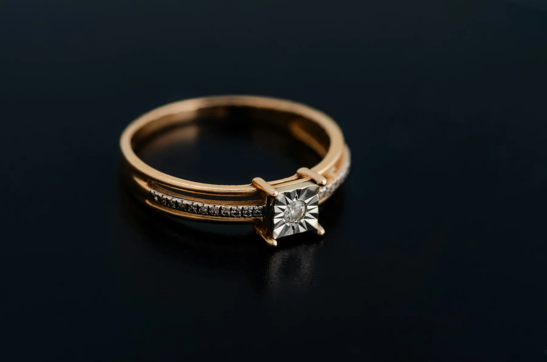 Nyra Solitaire Ring photographed against a dark ground
